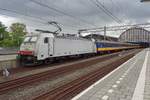 Macquarie 186 142 stands in front of an NS IC-Direct at Amsterdam Centraal on 9 July 2018.