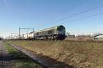 RailTraxx 266 024 hauls an intermodal train through Boxtel on 24 February 2021.