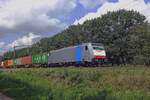 RailPool 186 453 hauls a container train through Tilburg Oude Warande on 12 August 2019.