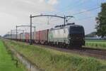 TX Log 193 280 passes through Hulten on 9 July 2021 hauling a container train toward Kufstein.