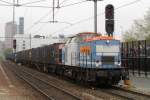 Nordbayerischer Eisenbahn NbE 203 160 is hired by LOCVON Benelux and hauls a refuse train through Tilburg on 4 April 2014. Note that the train rides wrong track. 