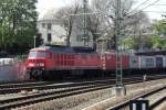 Ludmilla 233 525 hauls an intermodal train through a sunlit Dresden Hbf on 11 April 2014.