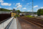 KSW 46 (also designated 277 807-4 / 92 80 1277 807-4 D-KSW)—a Vossloh G 1700-2 BB locomotive operated by KSW (Kreisbahn Siegen-Wittgenstein)—is shown passing through Kirchen/Sieg on June 18, 2026, hauling a loaded coil train towards Herdorf. The locomotive is required to run around the train in Betzdorf/Sieg to change direction.