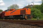 The Kreisbahn Siegen-Wittgenstein (KSW) with the northrail rental locomotive a MaK G 1206 on 18.05.2011 behindsignal box Herdorf East (Ho).