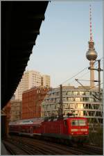 The DB 143 210-3 with a RE  by the S-Bahn Station Berlin Hackscher Markt. 17. 09.2012