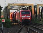 The Sun gets setting when on 16 September 2020 DBC 152 152 hauls her cereals train off the bridge through Celle, where your photographer shotts his picture from the platform.