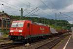 185 287-0 of the DB Schenker Rail runs on 03.08.2012 with a mixed freight train through the station Betzdorf/Sieg in the direction of Siegen.