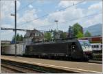 The MRCE E 189-997 is hauling a freight train through the station Arth-Goldau on May 24th, 2012.