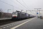 MRCE 189 989 hauls an intermodal train through Blerick on 16 December 2021.