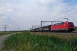 Block train hauled by 193 324 speeds through Valburg on 3 June 2020.