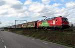 DBC 193 357 advertises the train as a green mode of transport while hauling a block train through Boxtel on 24 February 2021.