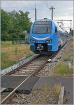 The Go Ahead (Bayern) ET 4.21 onthe way from Memmingen to Lindau Insel is arriving at  Hergatz.