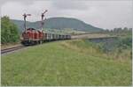 The diesel locomotive 211 041-9 (92 80 1211 041-9 D-NeSA) leaves the Epfenhofen Bridge valley crossing with its  morning train  and reaches Epfenhofen train station.