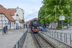 The steam locomotive 99 2322-8 stops at the Stadtmitte stop in Bad Doberan on the narrow-gauge line between Bad Doberan and Kühlungsborn before it leads the train the final stretch to Bad