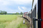 Train set on the narrow-gauge railway Mecklenburgische Bäderbahn on the section between Kühlungsborn and Heiligendamm. The photo was taken from one of the carriages. Date: 8th June 2025.