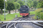 Steam locomotive 99 2322-8 from the Mecklenburgische Bäderbahn is running around at the terminus Kühlungsborn West. The locomotive is heading towards the train set standing at the platform. Date: 8th June 2025