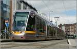 A  greenline  LUAS in Dublin by the Stephens Green.