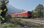 The bi-modular FS Trenitalia BUM BTR 813.001 from Torino to Aosta leaves the Chatillon Saint Vincent train station in the backlight. October 11, 2023