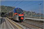 The FS Trenitalia ETR 104 094 is leaving Taormina Giardini station heading towards Catania.