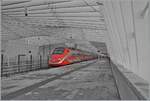 A  colorful  black and white picture: The FS Trenitalia ETR 500 with the power car in the new Frecciarossa color scheme at the stop in Reggio Emilia AV.