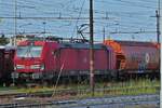 DB locomotive 191 018 is parked with its freight train in the siding of the freight yard in Verona.