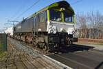 RailTraxx/CapTrain 266001 thunders through Blerick on 4 March 2022 -the photo was taken from a nearby road with fencing between your photographer (visible in the back ground) and the tracks.