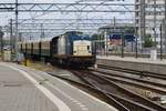 Volker rail 203-1 hauls a set of VSM two-axle coaches through Amsterdam Centraal on 9 July 2018. 