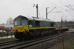 In appalling weather,RailTraxx 266 031 passes the railway crossings at Venlo-Vierpaardjes On a rainy 18 March 2017.
