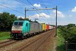 Alpha Trains/Crossrail 186 211 hauls the MSC shuttle through Tilburg Reeshof on 19 July 2020.