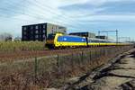 NS 186 042 banks an IC htrough Tilburg-Reeshof on 21 February 2021.