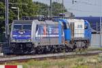 On 23 August 2019 RTB 186 300 hauls a Diesel loco through Tilburg.