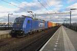 CrossRail/Rhenus 186 269 hauls a container train throguh Tilburg-Reeshof on 8 December 2021.