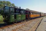 Tram loco SHM-18 hauls a typical steam tram of the Gooi out of Wognum-Nibbixwoud for Medemblik on 28 September 2013.