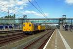 Broad view on Boxtel with ex-NS 2205 hauling a diagnostic coach passing through on 24 April 2019.