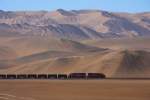 SPCC 31 & 33 ( both GP40 ) pass by a hillside writing -  Jesus loves us  - at km 38 above Ilo in Southern Peru