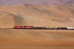 SPCC 32 & 61 ( GP40 + SD70 ) pass by a hillside writing -  Jesus loves us  - at km 38 above Ilo in Southern Peru