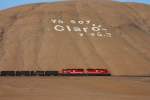 Yo soy Claro - y tu ? is an advertisement for a popular mobile telephone company in Peru, often depicted with white stones on the flanks of hills.

here, SPCC 31 & 33 pass such an over-simensioned billboard.