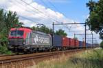 Far away from home, PKP Cargo EU46-513 hauls a container train to Tilburg-Industrie throguh Wijchen on 7 July 2020.