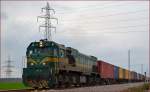 Diesel loc 664-112 pull container train through Cirkovce on the way to Koper port. /25.3.2014