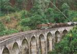 An unidentified Henschel Thyssen Class M6 locomotive pulling a mix train seen over nine arch via duct heading to Badulla on the hill country line in July 2012.