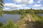 A part of the narrow gauge railway between Åseda and Virserum in Southern Sweden. The picture shows a damm on the lake of »Hjorten« just south of Virserum. Draisines can be hired in both towns.
Date: 18. July 2017.