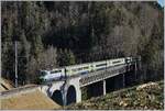 The BLS Re 4/4II 502 with an RE from Zweisimmen to Interlaken Ost on the Bunschenbach Bridge near Weissenburg.