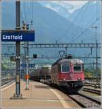 The Re 4/4 II 11634 is hauling a freight train through the station of Erstfeld on May 24th, 2012.