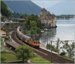 The SBB Re 420 320-4  InterregioCargo  with a Cargo train by the Castle of Chillon.