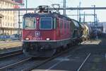 In the shadows: SBB 420 258 hauls a mixed freight through Pratteln on 13 February 2024.