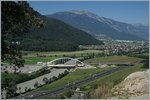 A SBB Re 460 with an IR by the new Rhone Bridge between Bex and St Maurice.