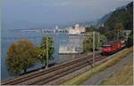 A SBB Re 460 with an IR to Brig by the Castle of Chillon.