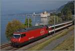 The SBB Re 460 037-5 with a IR to Brig by the Castle of Chillon.