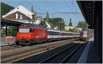 A SBB Re 460 with an IR27 and a SBB Re 6/6 with a Cargo train in Sissach.