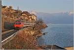 A SBB Re 460 wiht an IR to Geneva Airport by St Saphorin.